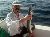 Donald Klein hlt einen gefangenen Fisch in den Hnden. (Quelle: dpa)